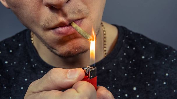 The person smoking medical marijuana joint close-up. Cannabis is - Фото, изображение