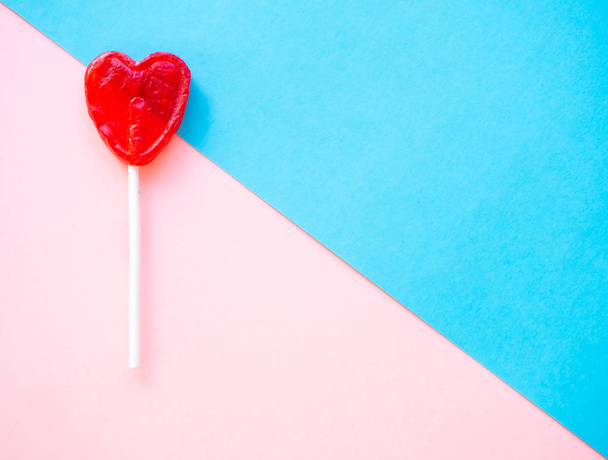 Red lollipop on a pink and blue background - Photo, image