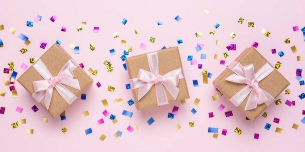 Colorful celebration background with various party confetti and gift boxes. Minimal party concept. Flat lay. - Foto, afbeelding