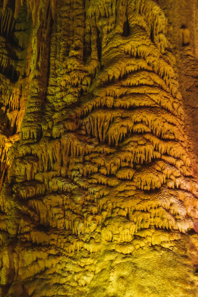 Prometheus Cave in Georgia. Multicolored lighting stalactite cave. Color lighting of stalactites in the cave. - Photo, Image