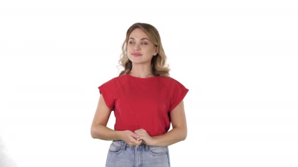 Happy young woman showing a product pointing with her finger to sides Presentation on white background. - Footage, Video