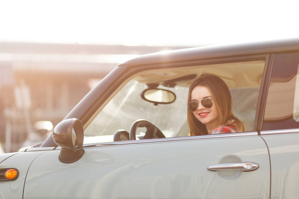 Young girl in sport car with black sunglasses. - Foto, Bild