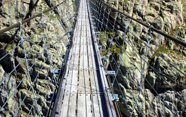 Suspension bridge in the high mountains - Photo, Image
