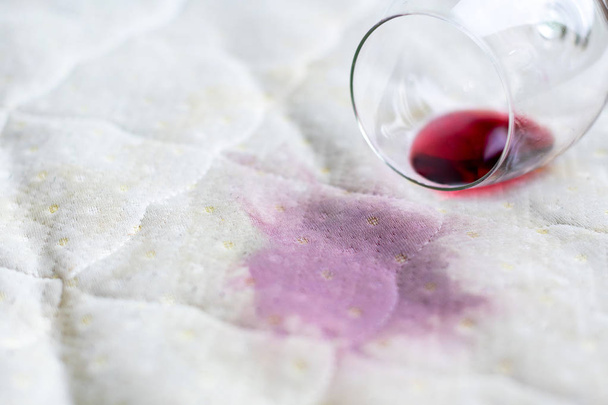 Bicchiere di vino rovesciato sul letto. Bicchiere da vino caduto accidentalmente su
 - Foto, immagini