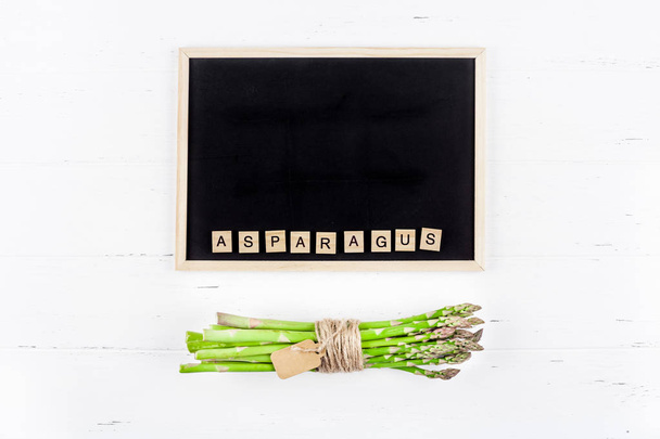Fresh green asparagus with black chalkboard frame - Photo, Image