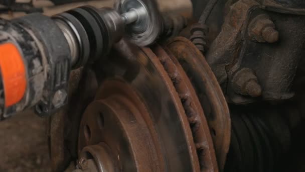 Male Cleans rust brake electric drill caliper before replacing the wheel. - Footage, Video