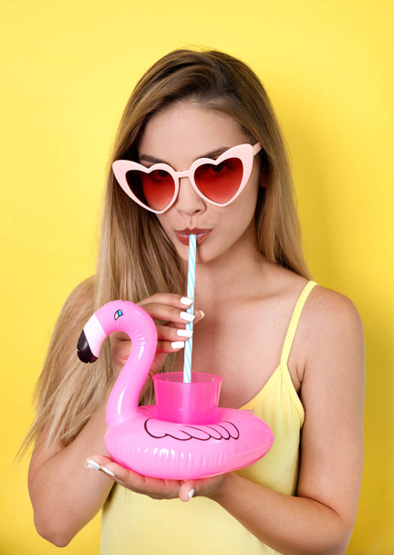 Young woman in sunglasses with cocktail  - Photo, image