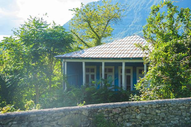 Casa de madera en la naturaleza en las montañas. Descanse en Georgia. Camina en Kutaisi. Casa vintage sobre un fondo de árboles verdes
. - Foto, imagen