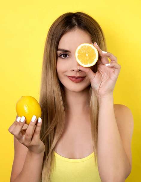 Young woman posing with lemons - 写真・画像
