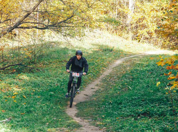 October 14, 2018, Minsk, Belarus.2018 Olympic Cross Country Cup XCO in Medvezhino Cyclist on the bike along the trail in the beautiful autumn forest - Photo, Image