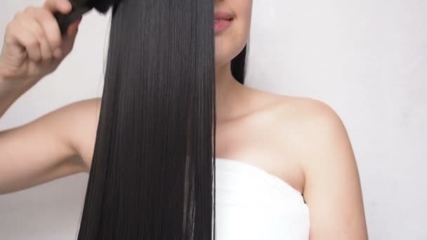 Menina jovem penteando cabelo liso longo depois de fazer um chuveiro
 - Filmagem, Vídeo
