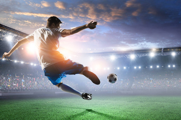 Soccer player on stadium in action. Mixed media - Foto, imagen