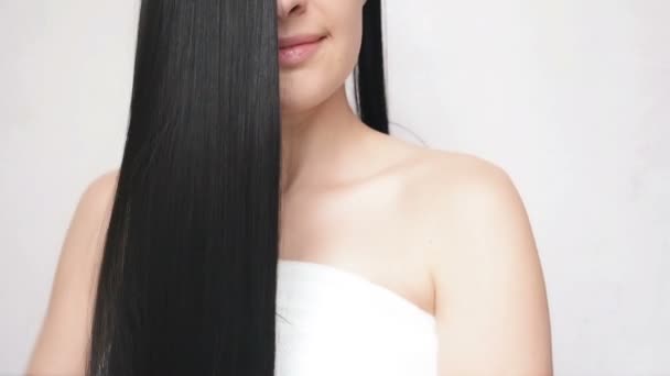 Young Girl Stroking Hand Over Long Hair Demonstrating Their Smoothness and Silkyness. Pretty Lady Cares Over Hair - Video, Çekim