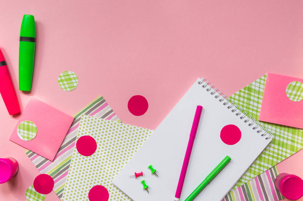 Pink and green markers and notepad for writing on a pink background flat top view with copy space, pattern from stationery accessories for school  - Φωτογραφία, εικόνα