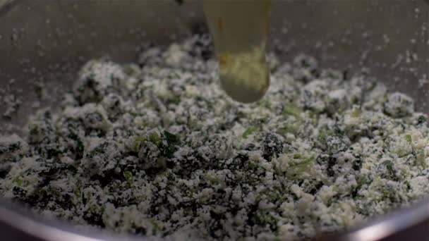 Adding eggs to ricotta and spinach Slow Motion - Filmmaterial, Video