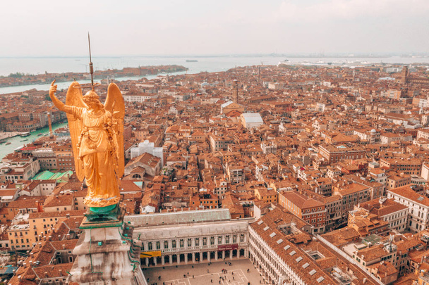 Gorgeous view of the golden statue of angel on top of clock tower in St Mark's Square, Venice, Italy  - Foto, Bild