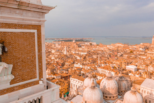 Architecture fragment of St Mark's Campanile (Campanile di San Marco) - famous bell tower of St Mark's Basilica and Loggetta at Piazza San Marco in Venice, Italy.  - Foto, Imagem