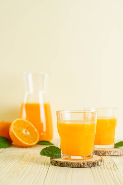 Fresh orange juice on wood background - Foto, immagini