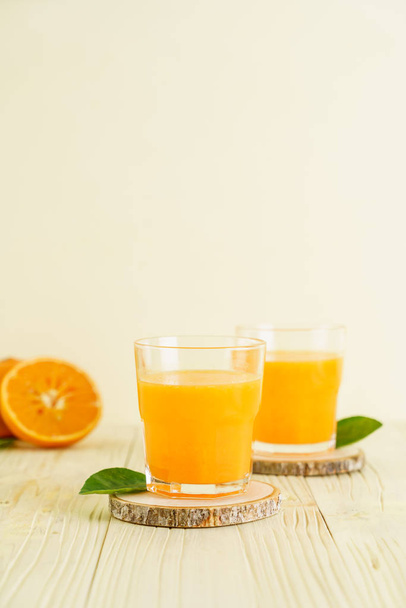 Fresh orange juice on wood background - Φωτογραφία, εικόνα