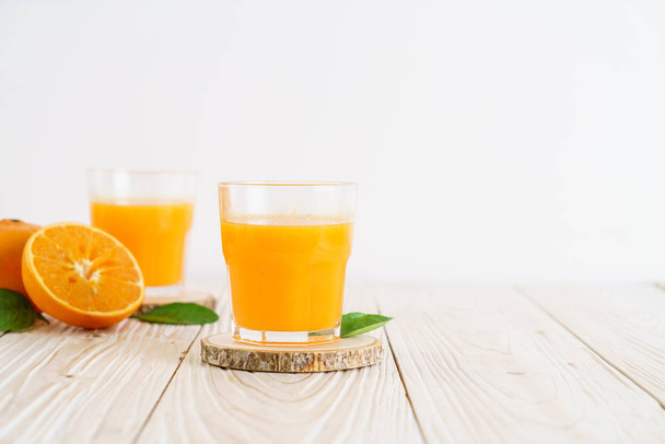 Fresh orange juice on wood background - Photo, Image