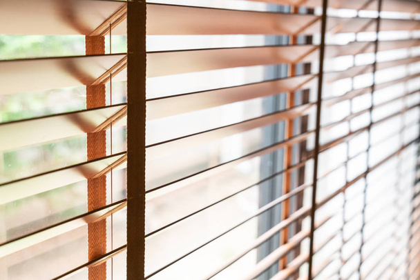 Wooden shutters on the window in the living room - 写真・画像