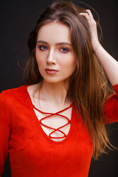 Young beautiful brunette model in red dress - Foto, afbeelding