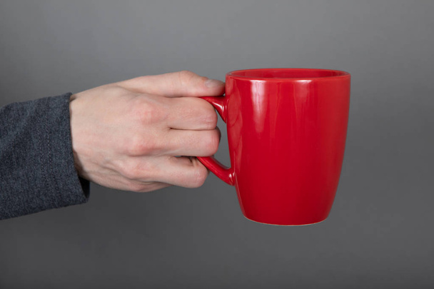 A man holding red mug - 写真・画像
