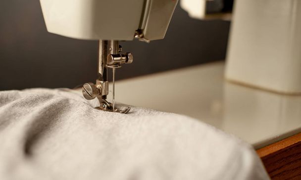 Cerrar vista de la máquina de coser coser tejido gris
  - Foto, Imagen