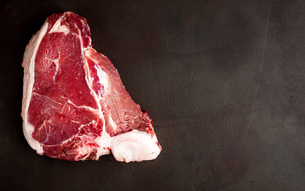 Raw bloody fat steak on stone background  - Foto, Imagem
