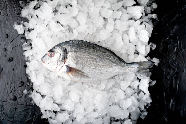 Vue rapprochée du poisson frais sur un tas de glace broyée à froid
 - Photo, image