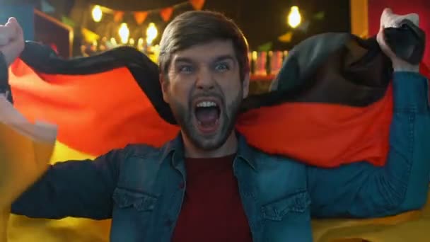 Extremely happy fan waving German flag, rejoicing national sports team victory - Filmagem, Vídeo