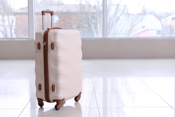 Packed suitcase in empty room - Photo, image