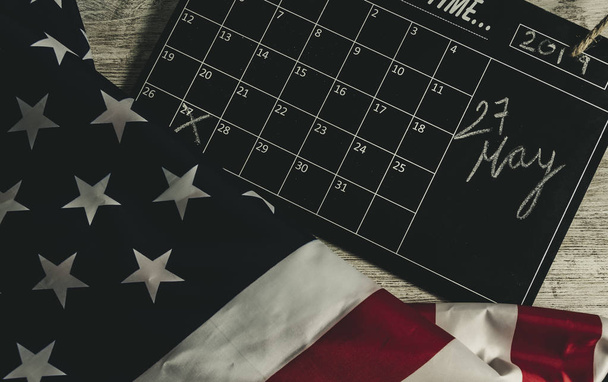 27 May date in calendar under american states flag, and all on wooden table, vintage style - Photo, Image