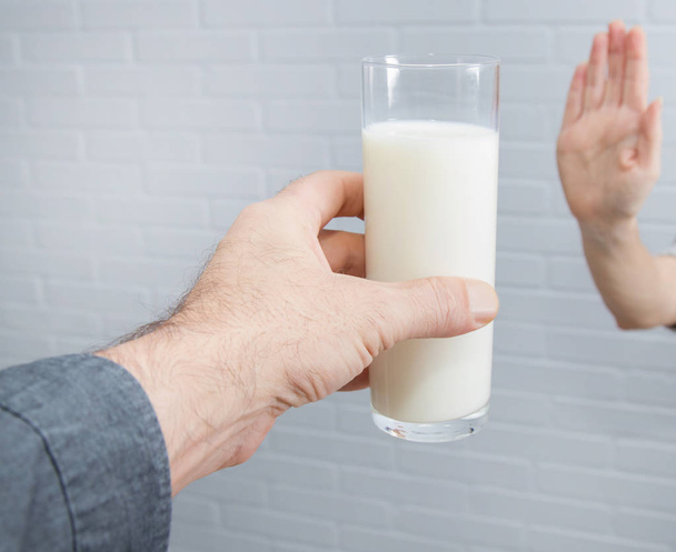 hand rejecting the glass of milk, intolerance to dairy - Fotoğraf, Görsel