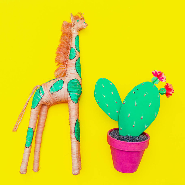 Wooden cactus and giraffe on a yellow background. Souvenir. Mini - Photo, Image
