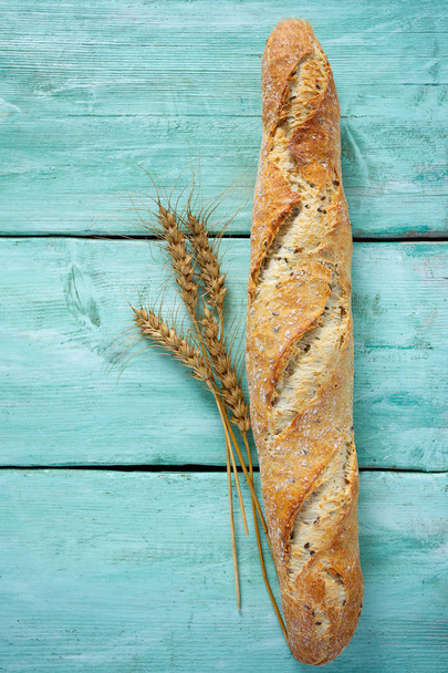 Fresh crunchy baguette on wooden surface - Foto, immagini