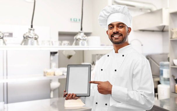 indian chef with tablet pc at restaurant kitchen - Foto, imagen