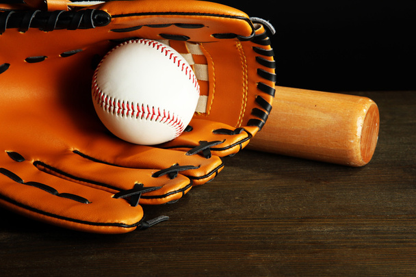 Baseball glove, bat and ball on dark background - Foto, Bild