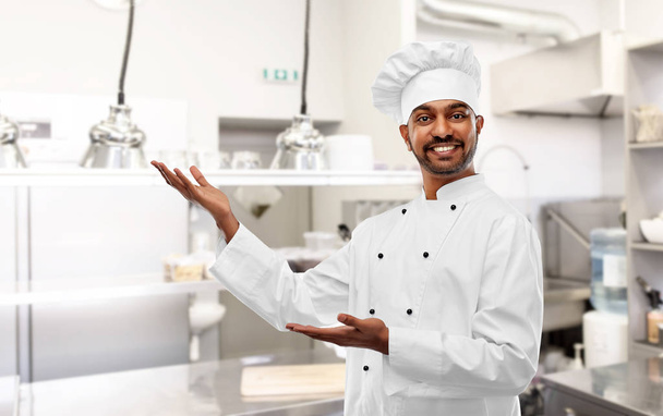happy male indian chef presents restaurant kitchen - Fotografie, Obrázek