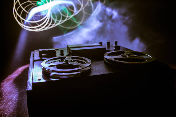 Old vintage reel to reel player and recorder on dark toned foggy background. Analog Stereo Open Reel Tape Deck Recorder Player with Reels. - Photo, Image