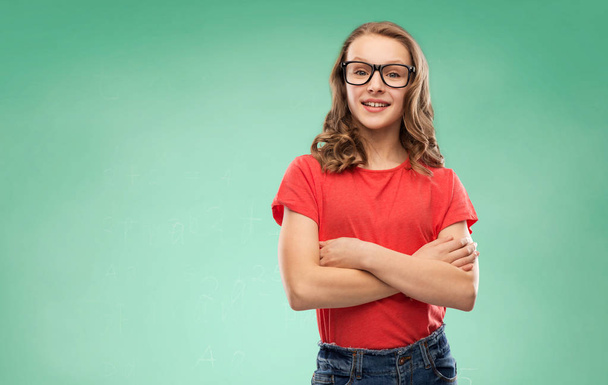 smiling student girl in glasses over green board - Fotó, kép