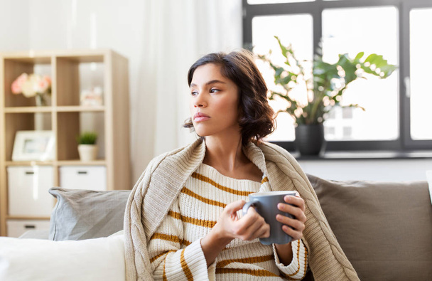 sad sick young woman drinking hot tea at home - Valokuva, kuva