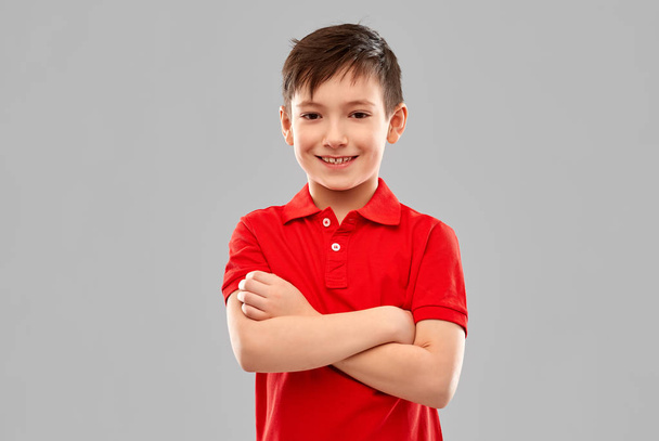 smiling boy in red t-shirt with crossed arms - Photo, Image