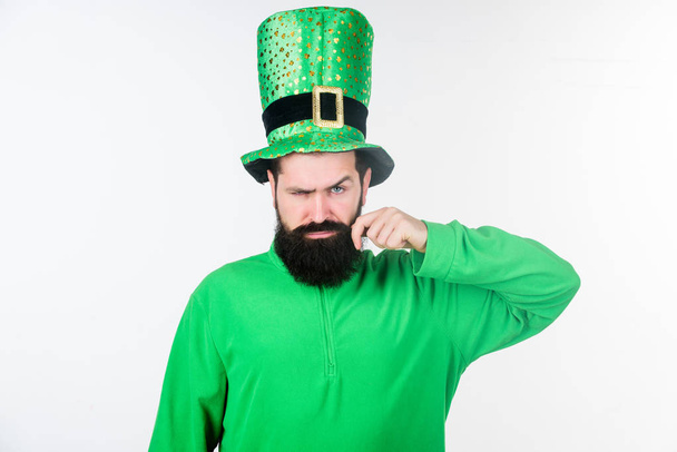 Happy saint patricks day. Hipster in leprechaun hat and costume. Bearded man celebrating saint patricks day. Irish man with beard wearing green. He has moustache - Photo, image