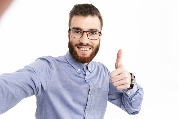 Smiling bearded elegant man in eyeglasses showing thumb up - Foto, Imagem