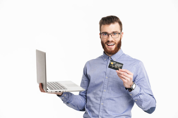 Happy bearded elegant man in eyeglasses holding laptop computer - Foto, Bild