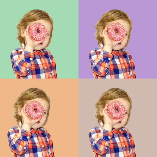 Little happy cute boy is eating donut on green background wall. Child is having fun with donut. Tasty food for playing kids. Funny time  with sweet food. Bright baby boy in a plaid shirt. - Foto, Bild