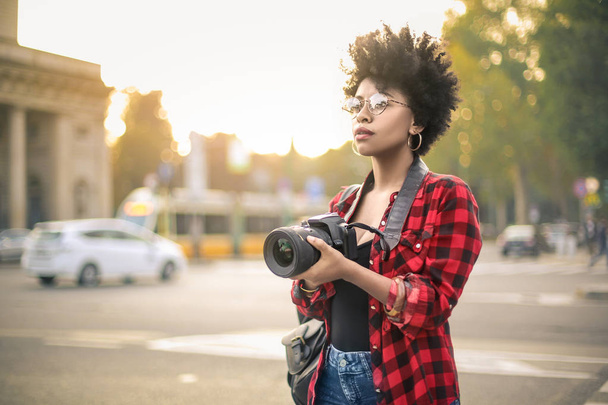 Krásná Africká Američanka se kudrnatými vlasy s fotografickou kamerou - Fotografie, Obrázek