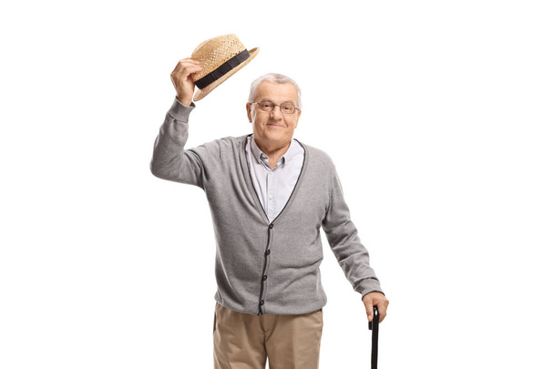 Senior man greeting with his hat isolated on white background - Foto, Imagem