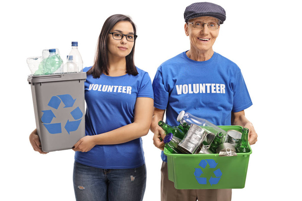 Young female volunteer and a senior man volunteer with recycling bins isolated on white background - Fotoğraf, Görsel